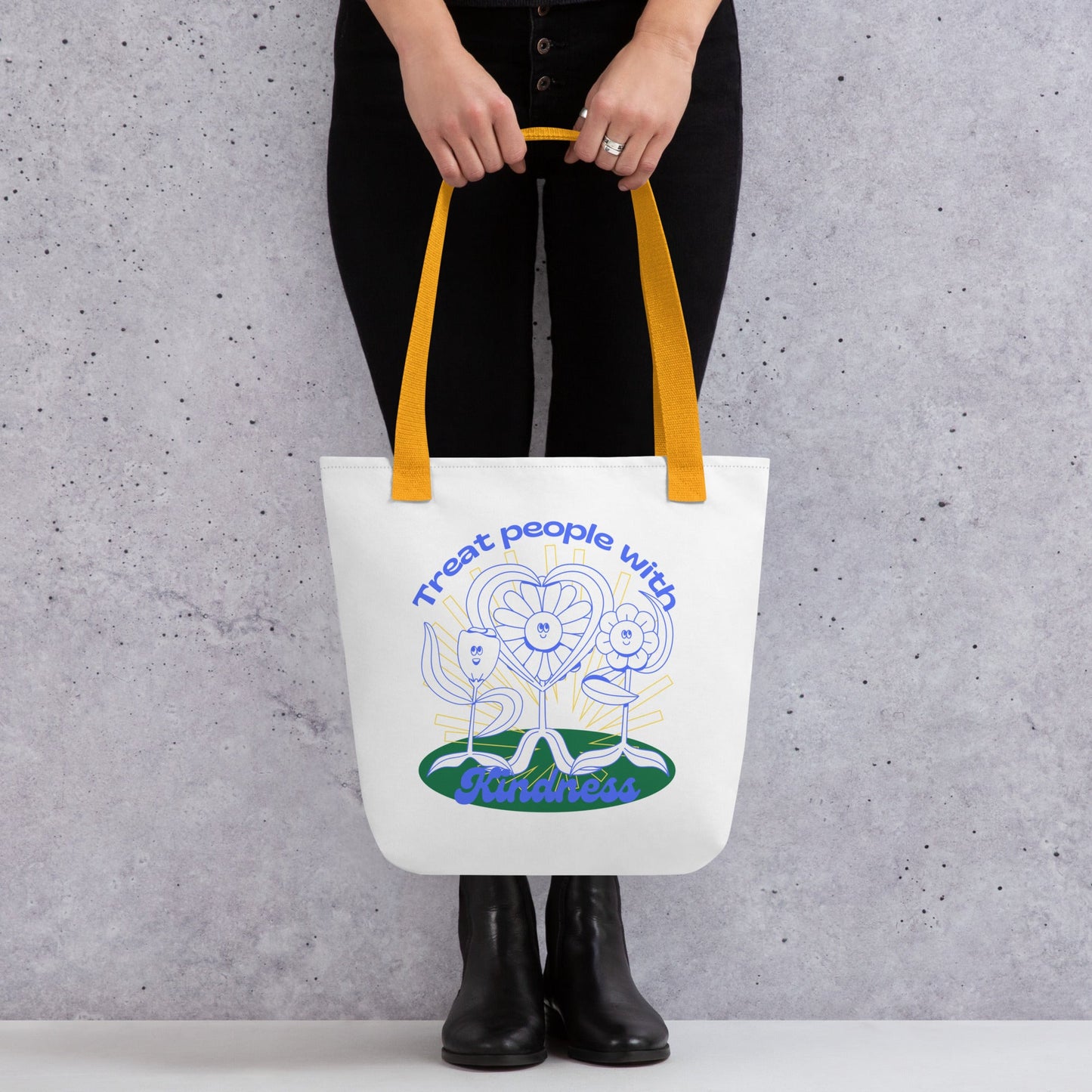 Tote bag with a design and text held by a person against a gray background