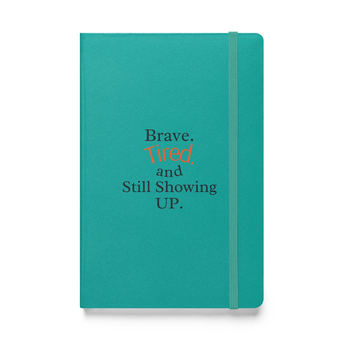 Teal notebook with text 'Brave. Tired and Still Showing UP.' on a white background