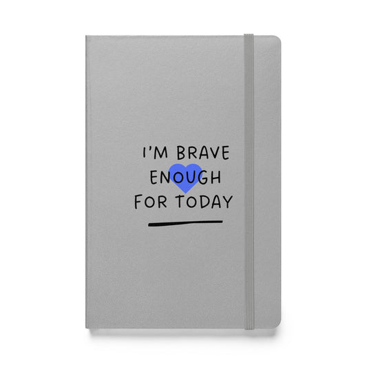 Gray notebook with 'I'm brave enough for today' text and blue heart on a white background