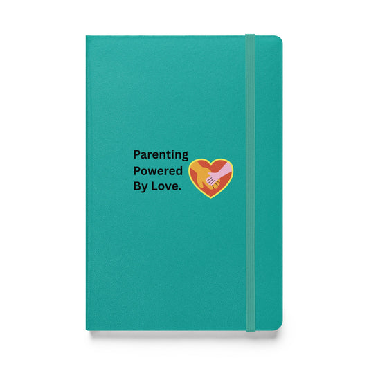 Teal notebook with 'Parenting Powered By Love' text and heart design on a white background