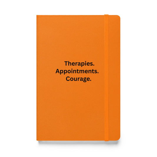 Orange notebook with black text on a white background