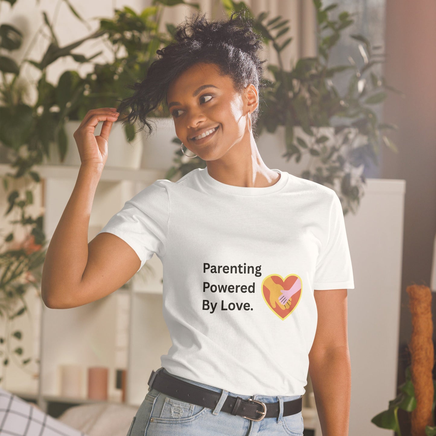 Woman wearing a white t-shirt with 'Parenting Powered By Love' text and heart graphic.